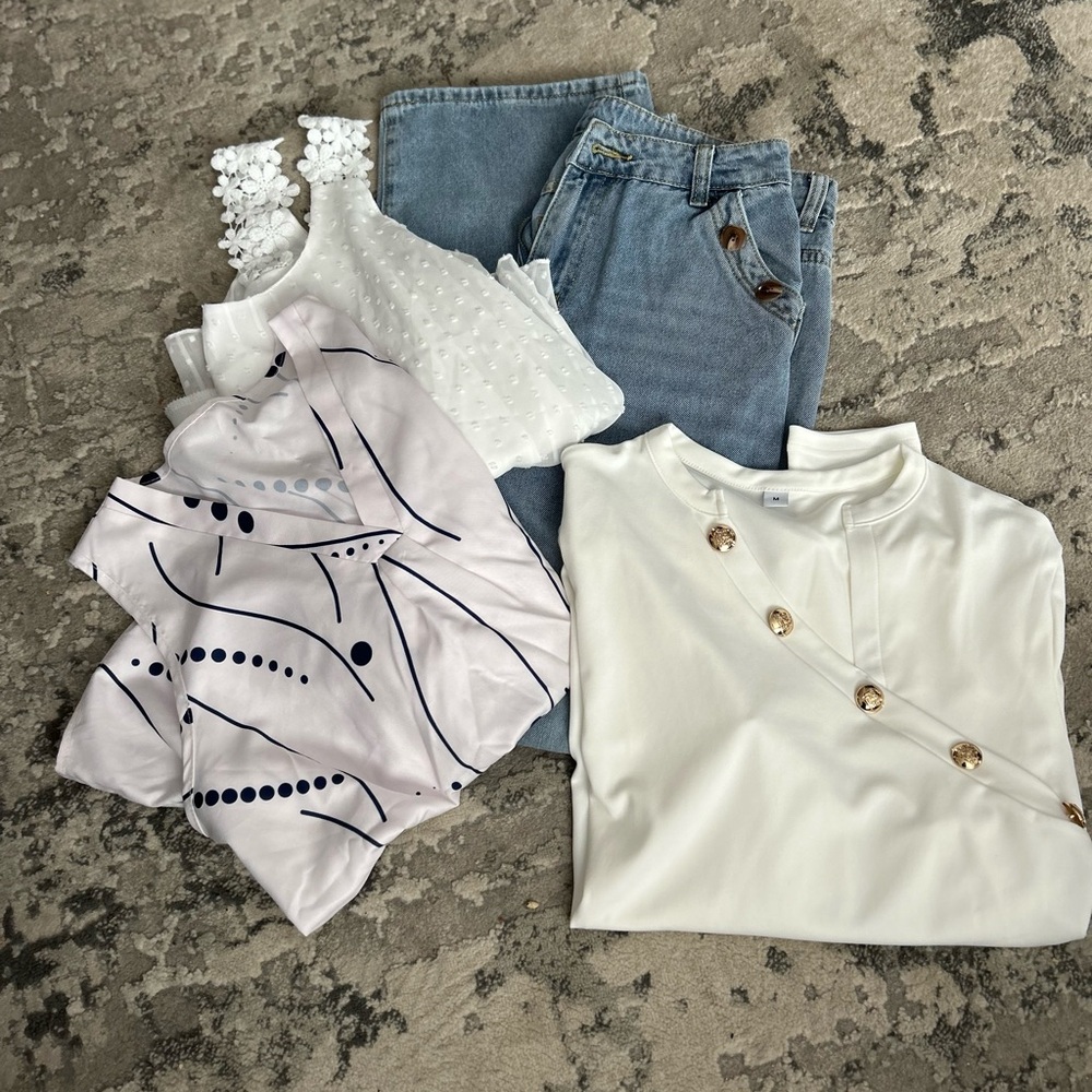 Bundle of jeans and white blouses
